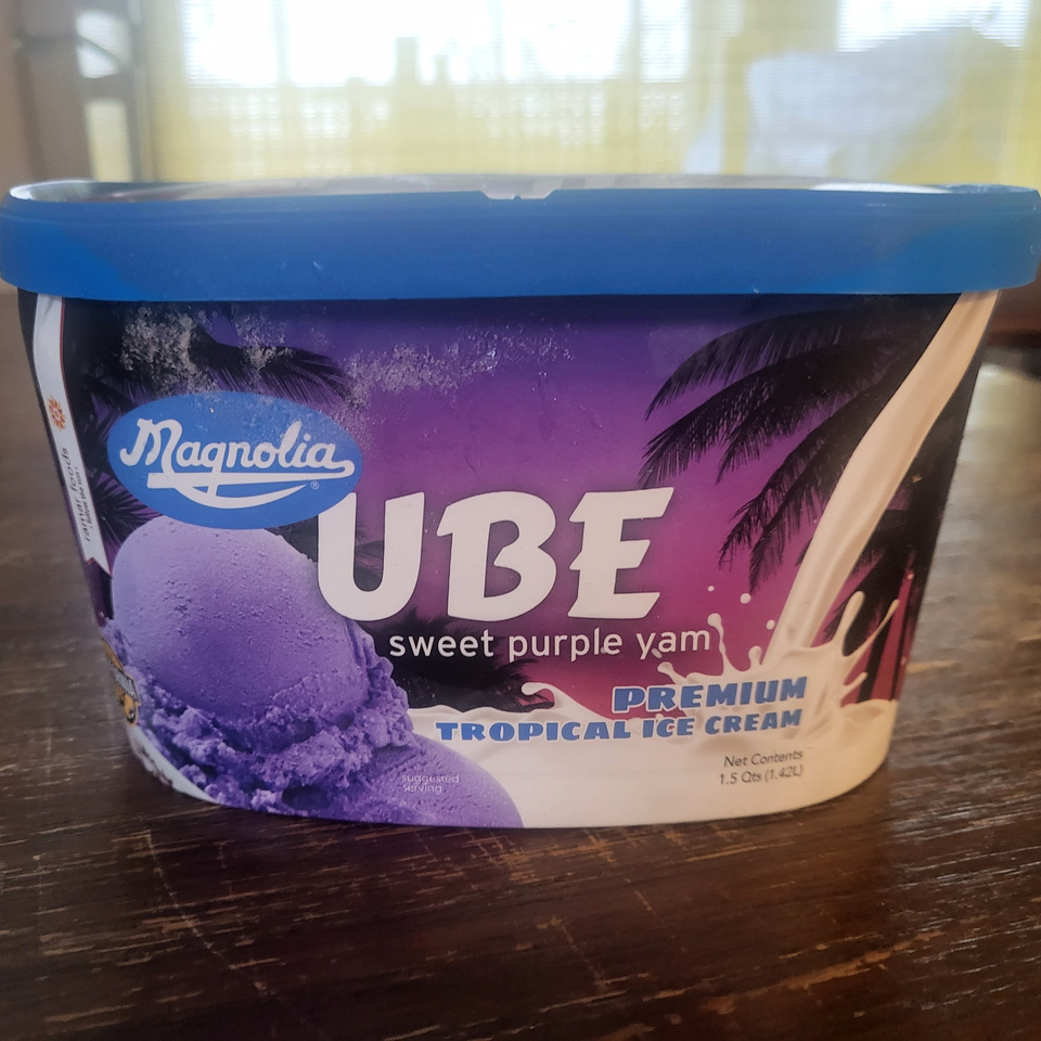 A tub of Magnolia Ube Sweet Purple Yam Premium Tropical Ice Cream with a blue lid.