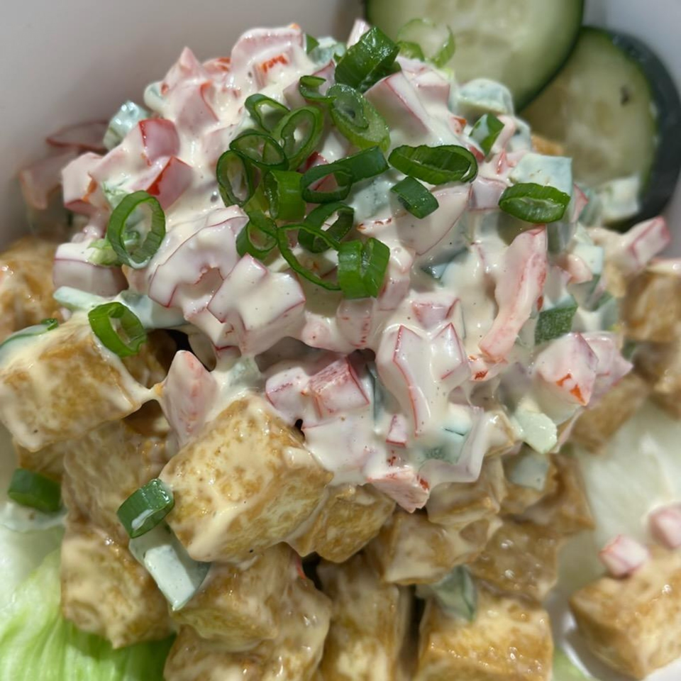 Close-up of Kuya’s Islander Cuisine’s tofu salad with creamy dressing, diced vegetables, and green onions.